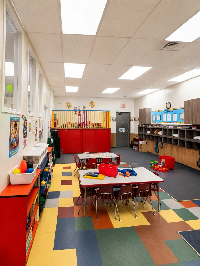 The Ideal Daycare toddler room with a colourful tiled floor and activity tables